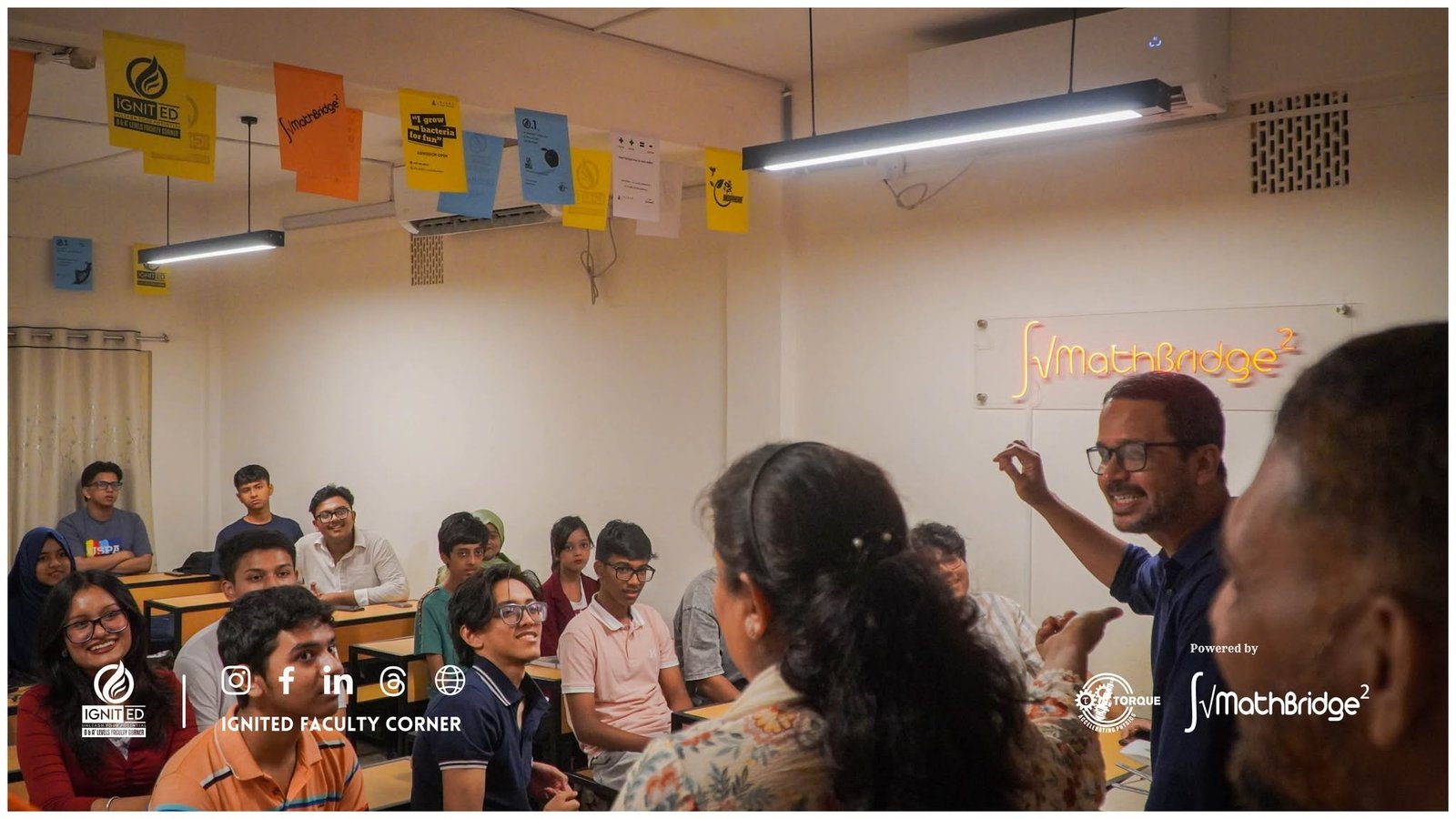 An enthusiastic teacher instructing attentive students during a MathBridge class at IgnitED Faculty Corner.