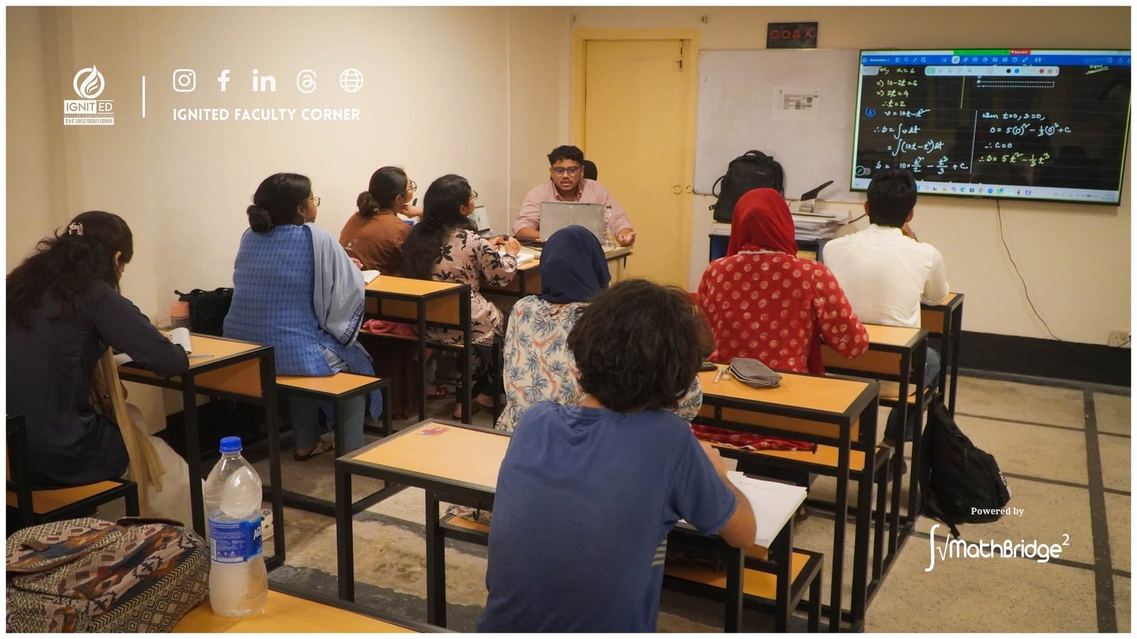 A MathBridge instructor teaching a math class at IgnitED Faculty Corner using a digital smartboard.
