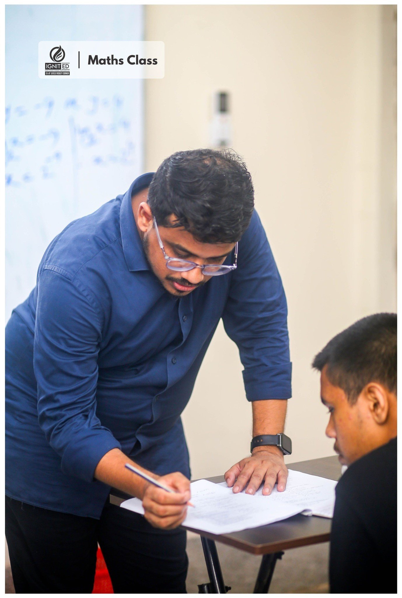 IgnitED tutor guiding a student one-on-one through an O Level Mathematics problem